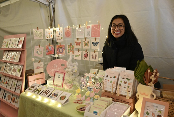 Artist Merissa shows her pastel-coloured art at the Pinoy Night Market. Photo by Yona M. Harvey, Mabuhay Canada Media