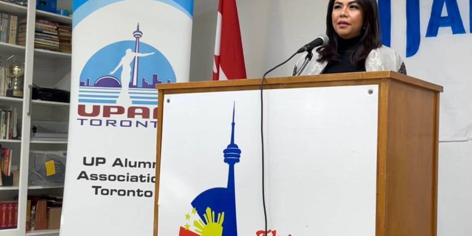 Filipina McLuhan Fellow winner Karmina Constantino is pictured speaking at a podium labeled The Filipino Centre