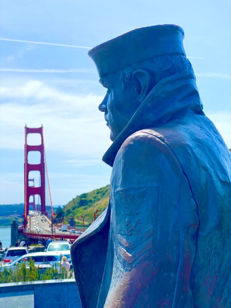 The Lone Sailor statue in the foreground, with the Golden Gate Bridge in the background