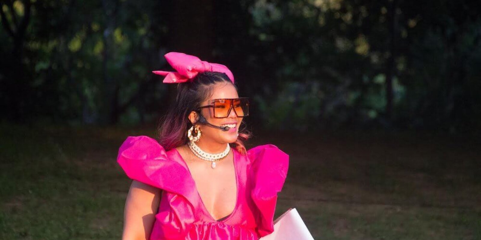 Filipina comedian Fly Lady Di in a pink dress and glasses