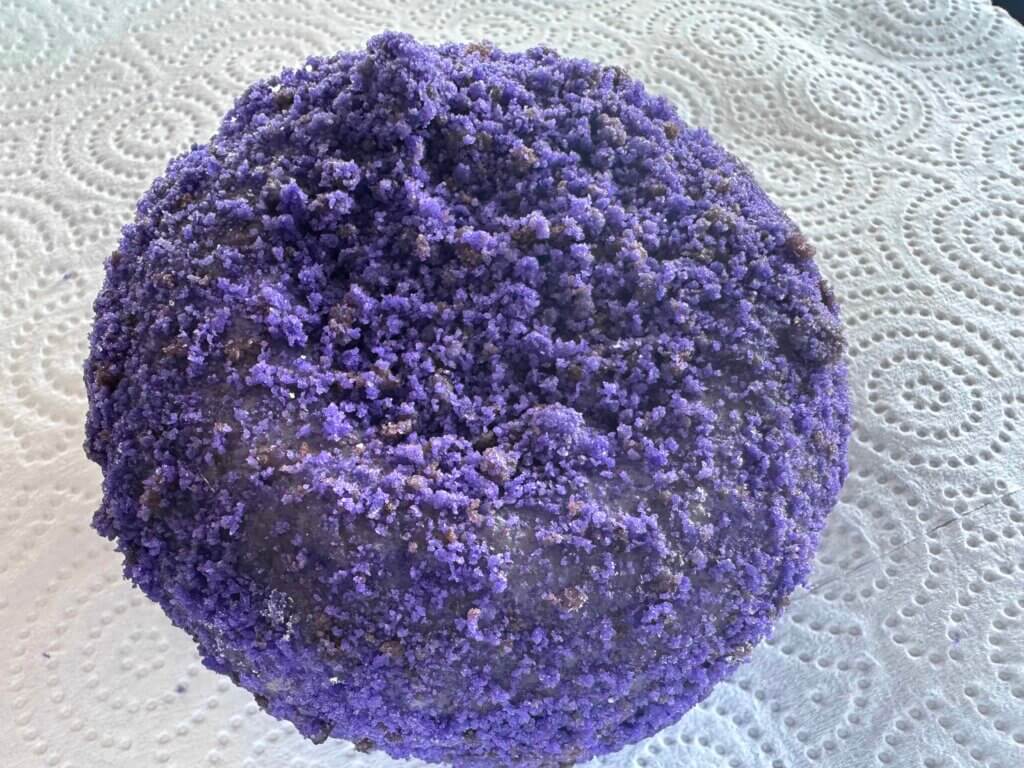 A photo of a round, purple donut