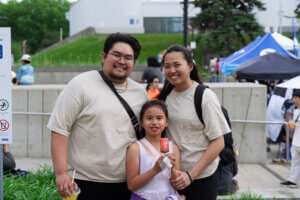 Frank Dela Cruz, Christine Caranto and a young family member attend the Pinoy Fiesta & Trade Show on June 7. The couple said they came to support Filipino culture and local vendors. Photo by Luis De Castro.